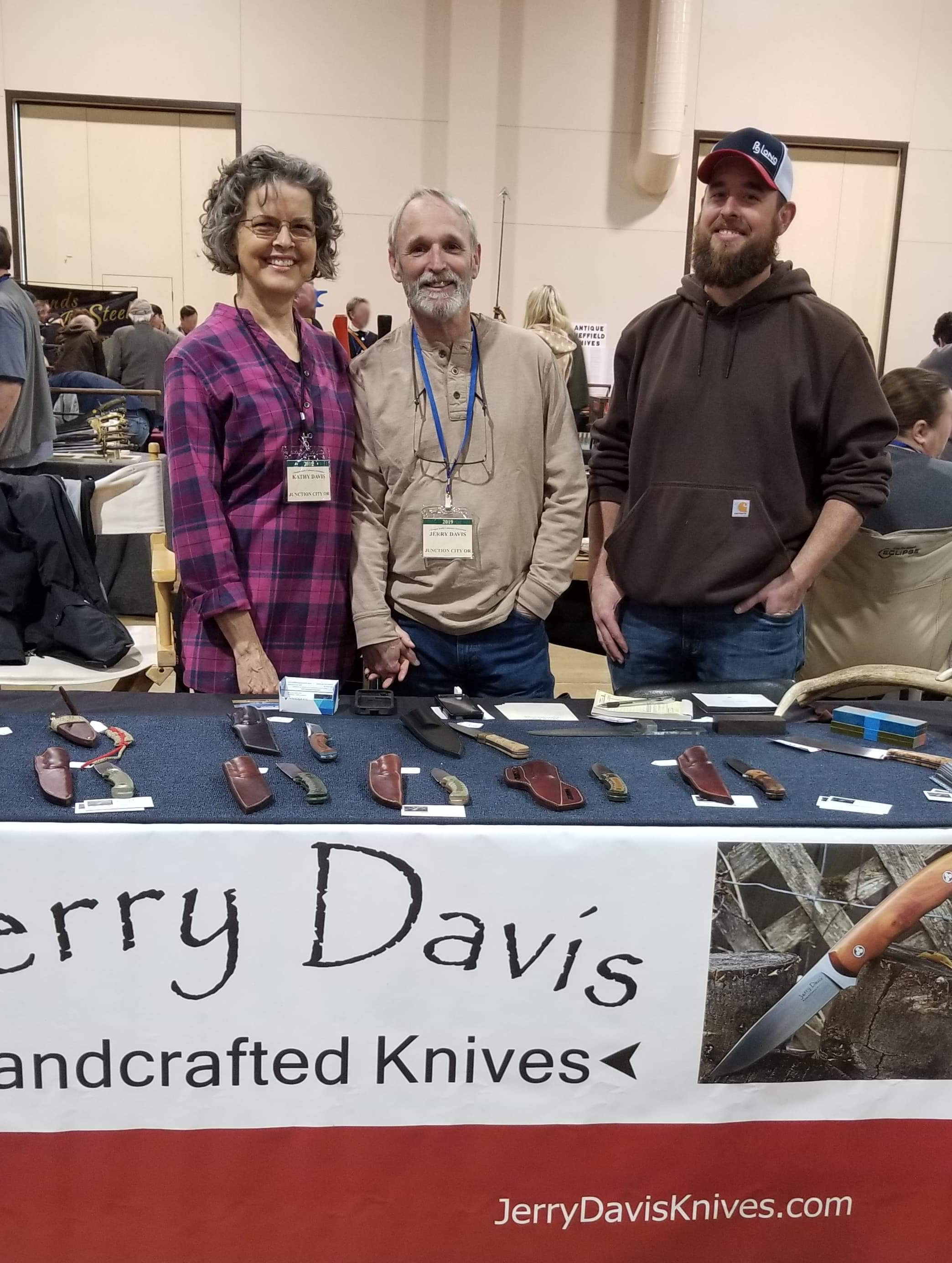 Jerry Davis at his table at the knife show with wife and son in Eugene Oregon with his wife Kathy and son Seth April 2019